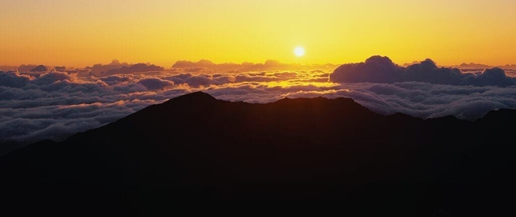 This is sunrise from Haleakala Volcano Summit located at Haleakala National Park. These are the cloud formations over the top of the volcano.