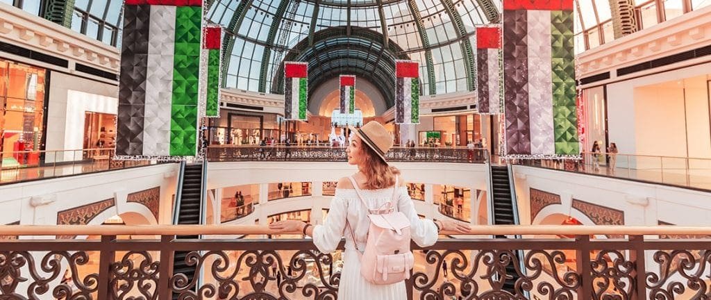 A young tourist walks through one of the largest shopping centers in Dubai - Emirates Mall. Travel in UAE concept