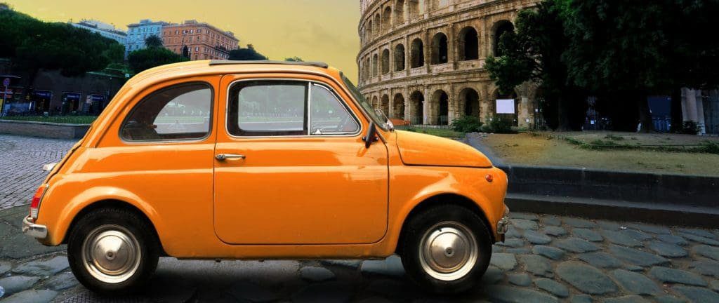 Retro car on background of Colosseum in Rome