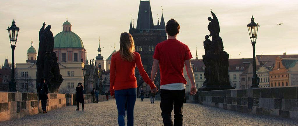 A couple walking in Prague - Charles Bridge