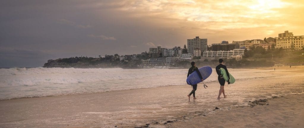Surfers leaving Bondi beach of Sydney in the evening