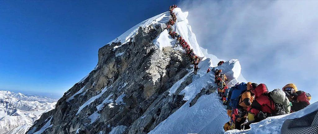Everest peak crowded by people causing great risk of accidents and fatalities