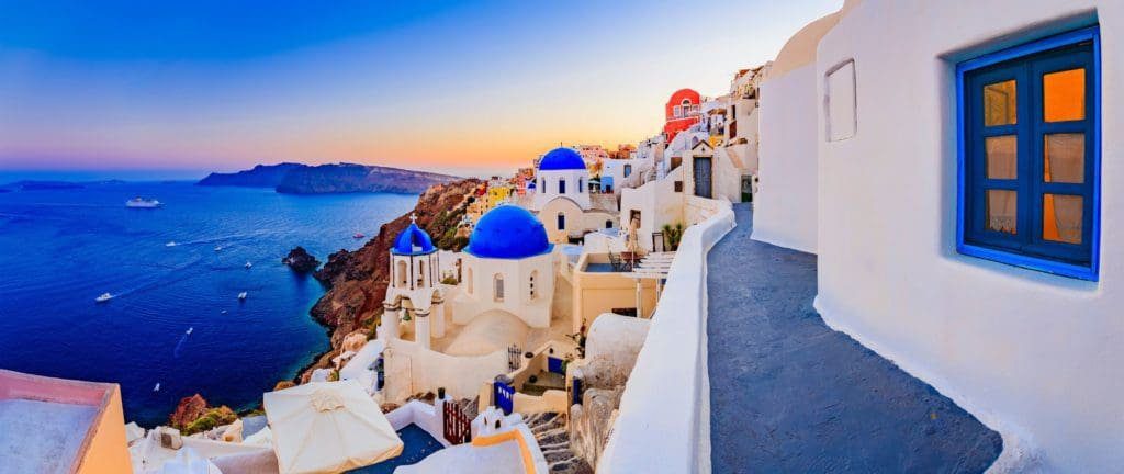 Iconic white-washed buildings with blue-domed roofs in Santorini
