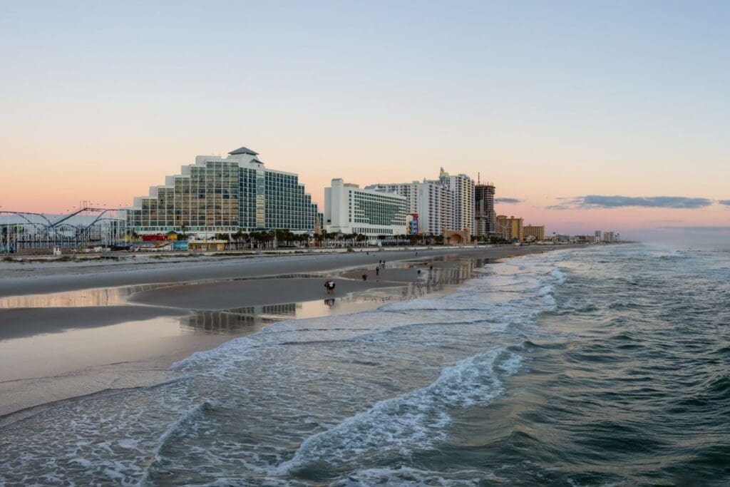 Panoramic view of a sandy Daytona beach during a vibrant sunrise