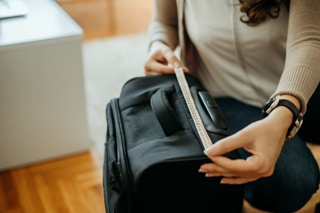 Woman measuring carry-on luggage size